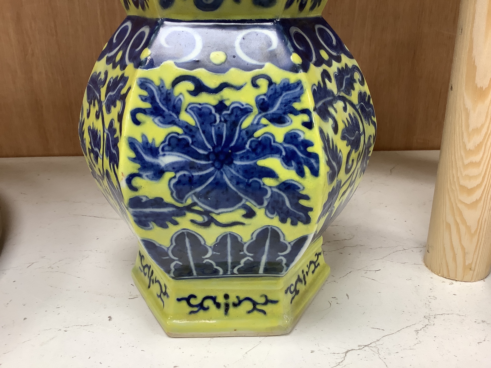 A Chinese underglaze blue yellow ground hexagonal vase, early 20th century, some restoration 35cm